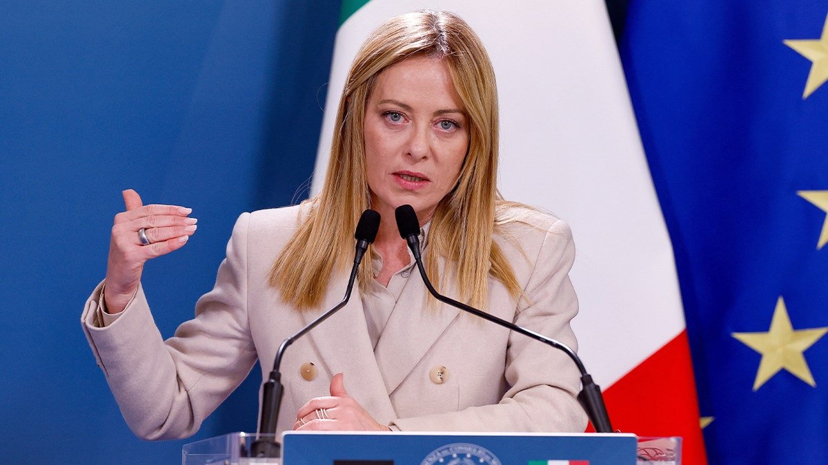 Italy’s prime minister delivers remarks at a podium during a diplomatic event.