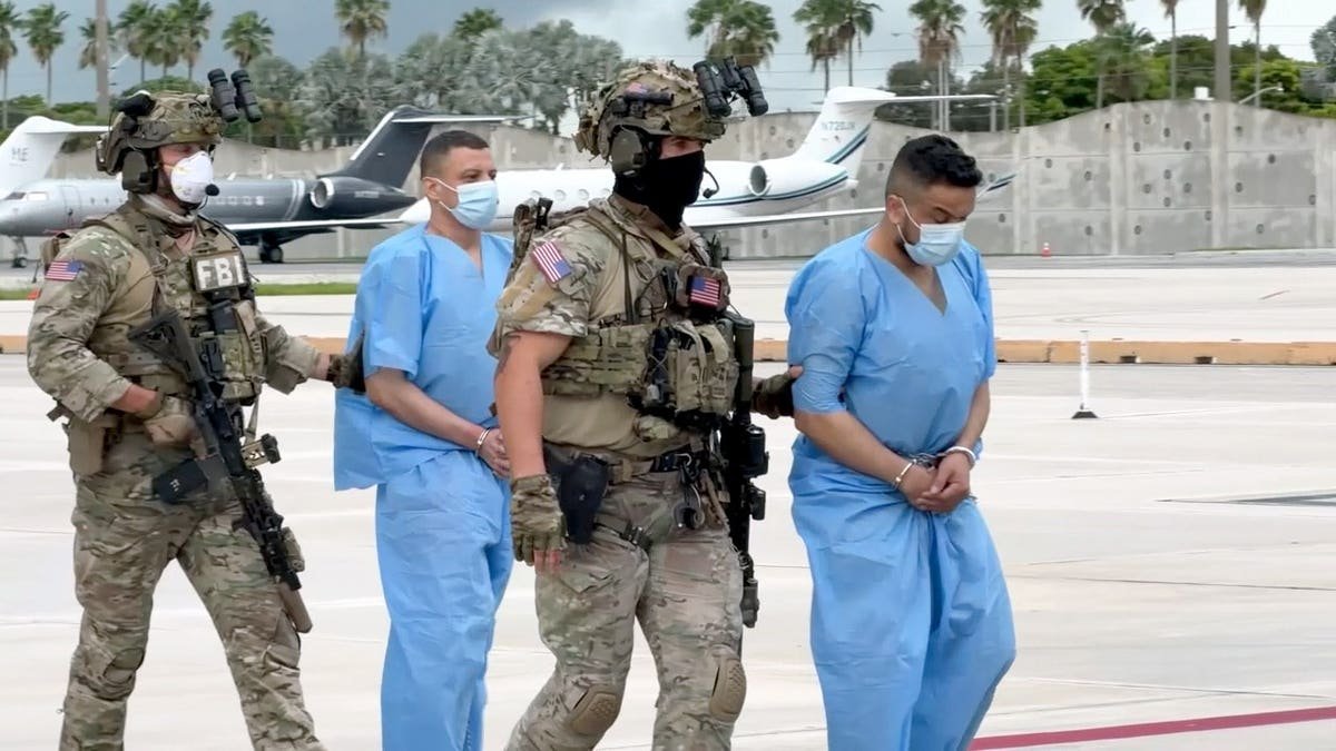 exclusive tarmac video serves as the only visual of the suspects entering U.S. custody