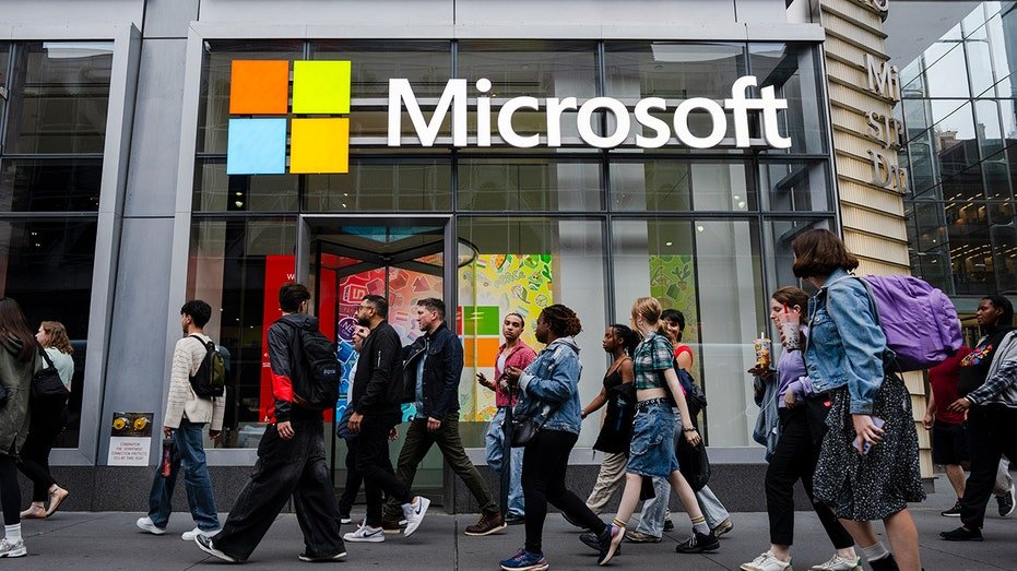 People walk by the Microsoft Office