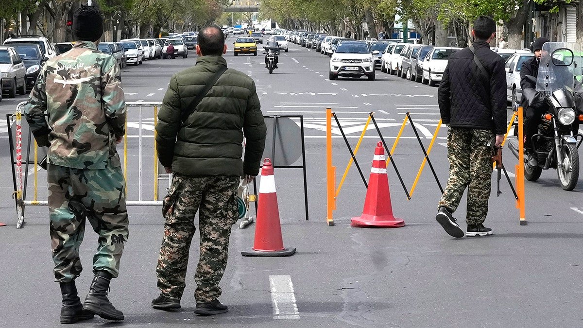 Members of the Basij paramilitary force standing at a checkpoint.