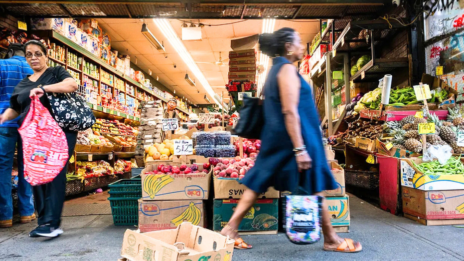 A woman is seen walking by a NYC bodega.