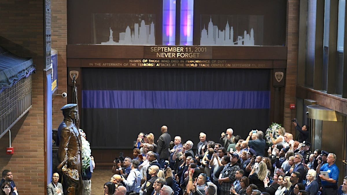 People gather at One Police Plaza for a 9/11 Memorial Wall unveiling ceremony in New York City.