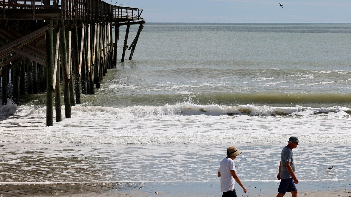 People walk on beach on Pawleys Island