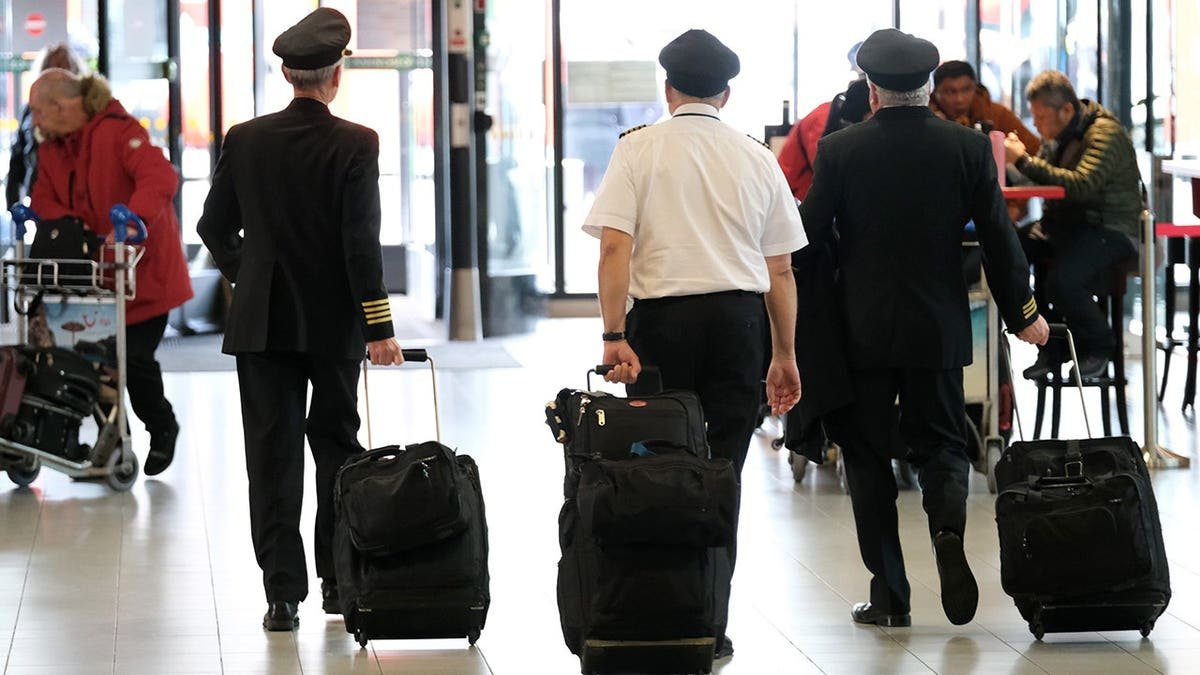 Pilots walk through Schiphol airport in the Netherlands.
