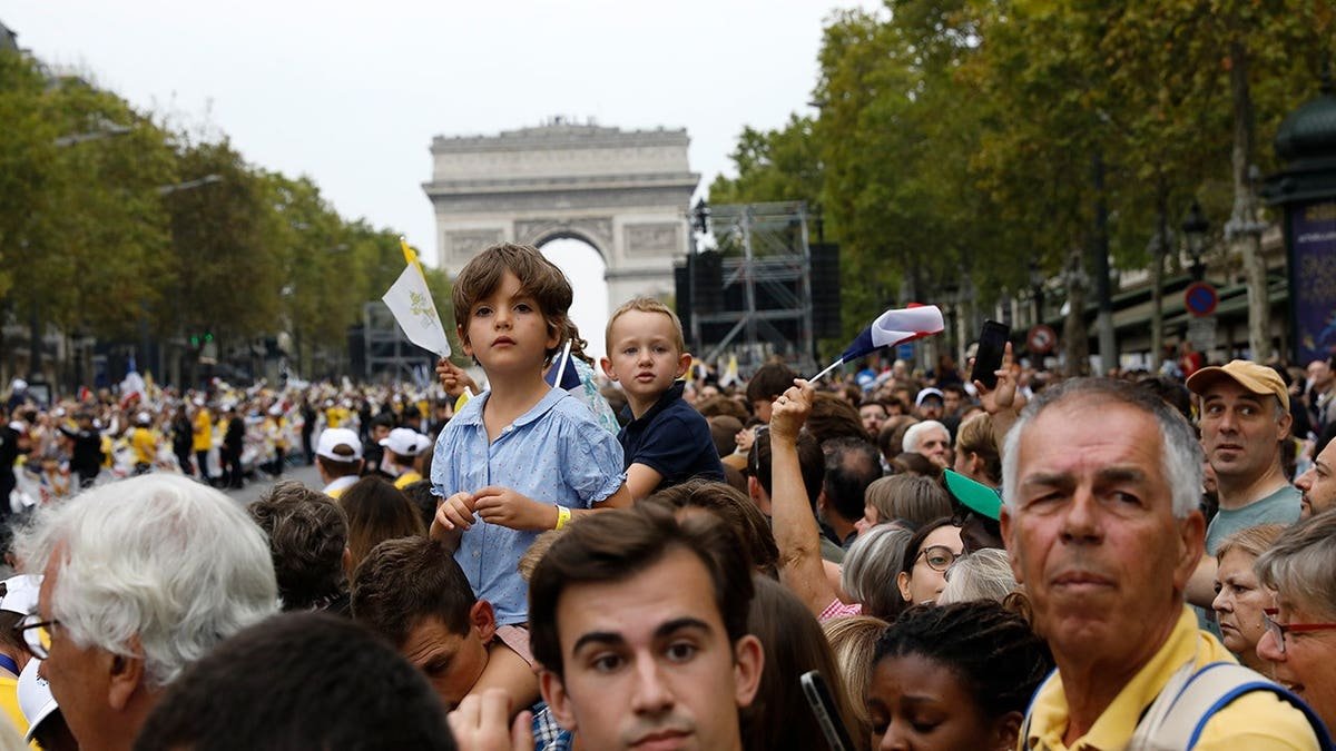 Pope Leo XIV celebrates an outdoor mass with worshippers gathered on the Champs-Élysées in Paris.