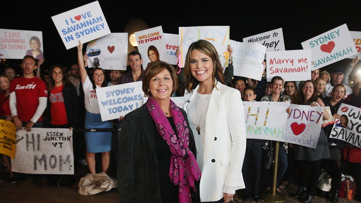 Savannah Guthrie and Nancy Guthrie posing together on an outdoor set with the Sydney Opera House in the background.