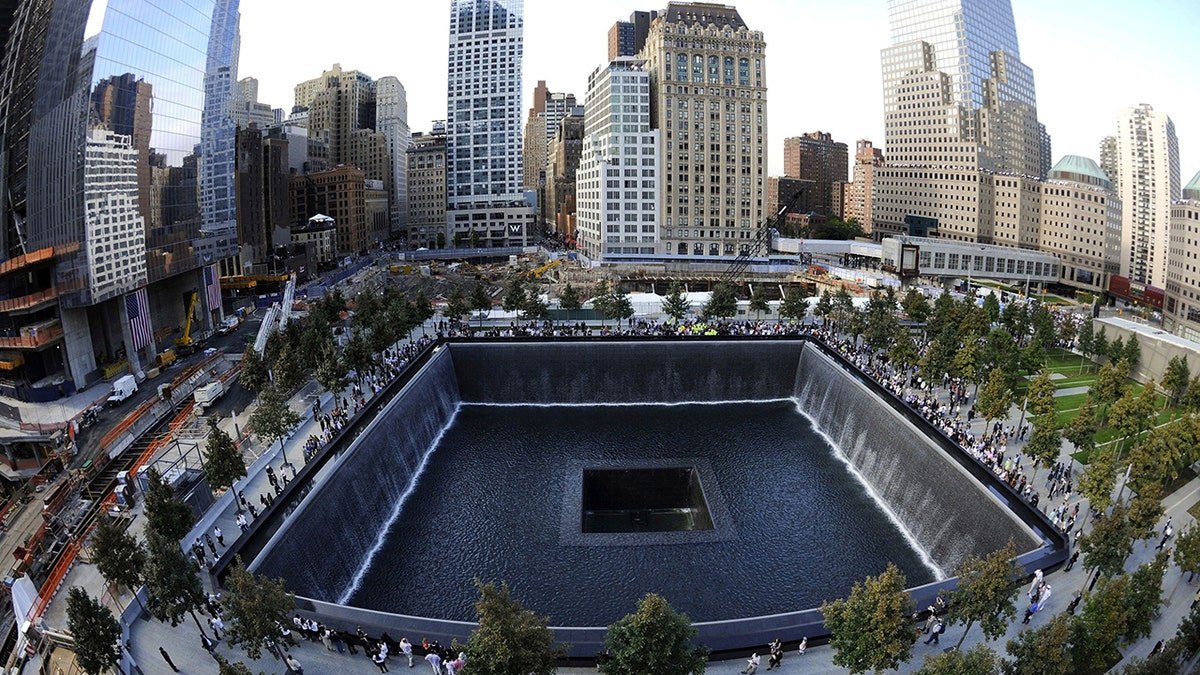 Families visit the South Memorial Pool during 10th anniversary ceremonies at the World Trade Center site in New York City.