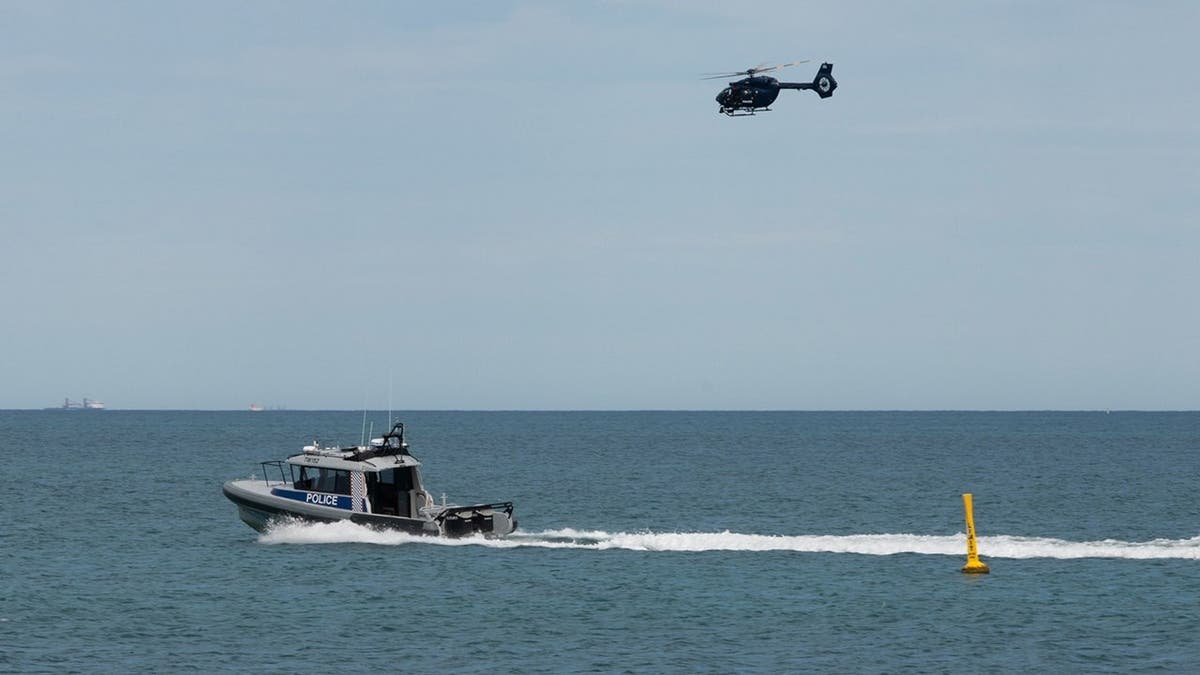 Police boat and helicopter patrol Sorrento Beach in Perth, Australia.