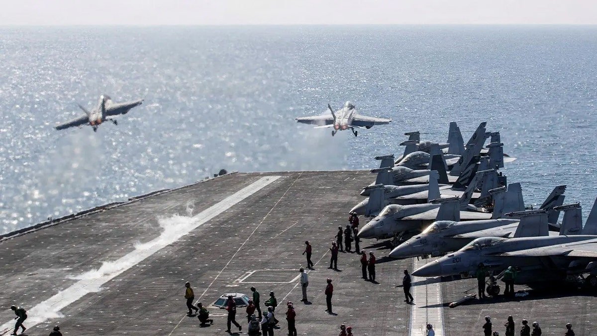 Two F/A-18 Super Hornets launch from flight deck of USS Abraham Lincoln during Operation Epic Fury